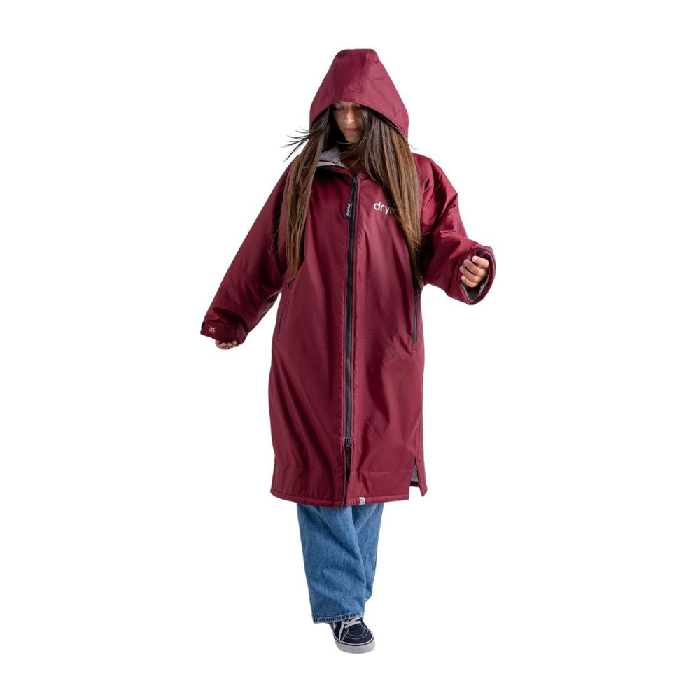 Person wearing a maroon raincoat on a white background