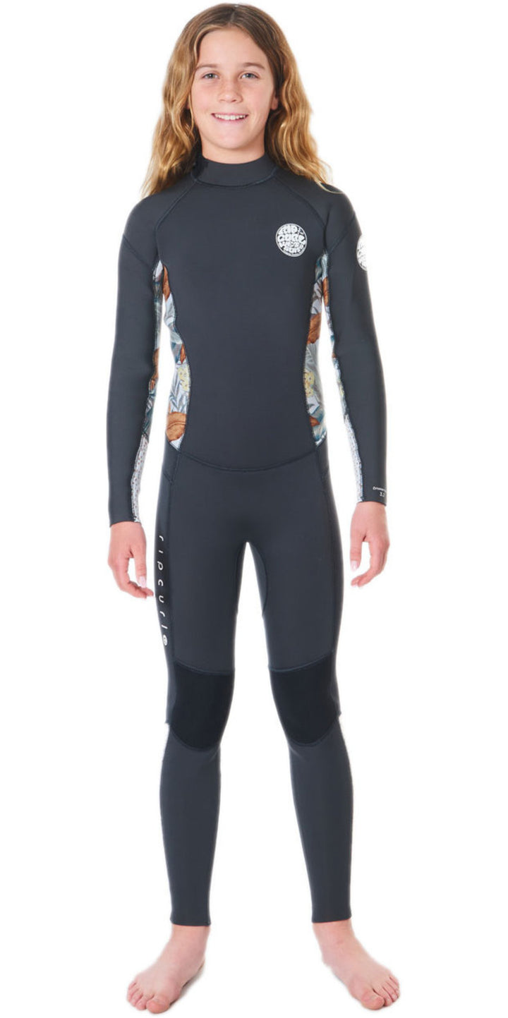 A girl wearing a black and multicolored floral Rip Curl wetsuit with a back zip.